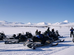 Snowmobile safari in Lapland mountains