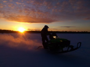 Snowmobile sunse arctic winter