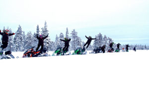 Guests jumping of Snowmobiles