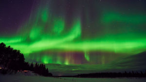Northern lights over river - Lapland Guesthouse