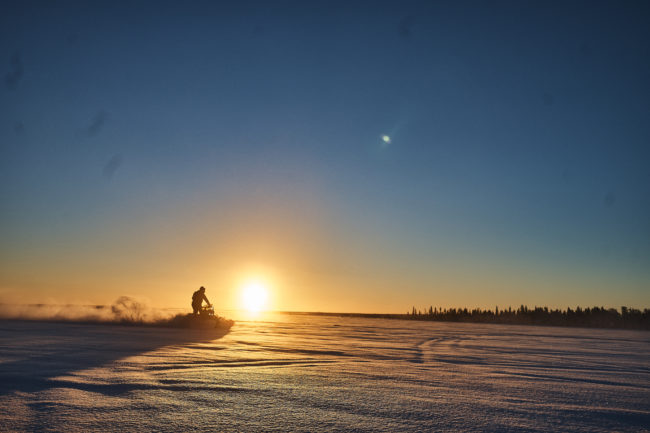 On Snowmobile trough the sunset